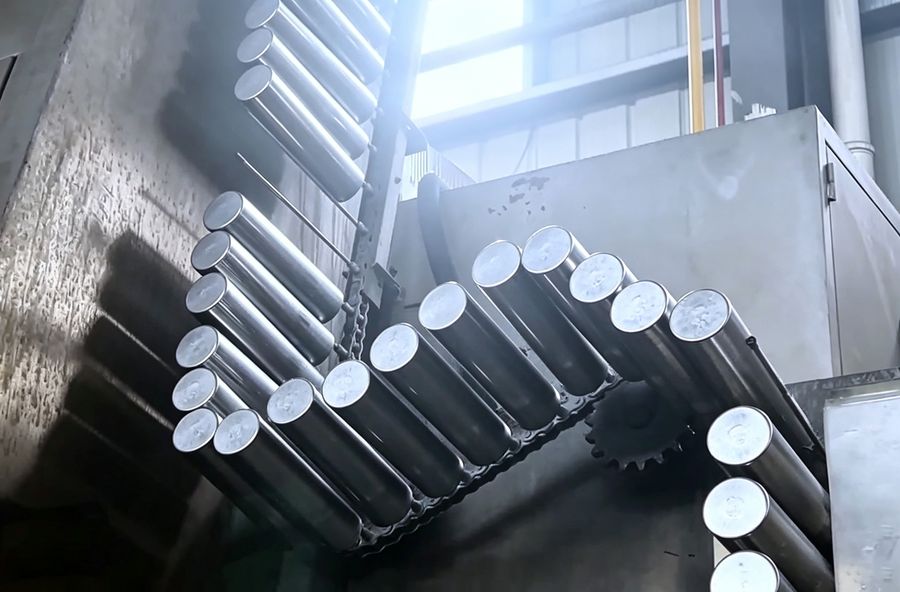 Can bodies transferred overhead between process stages